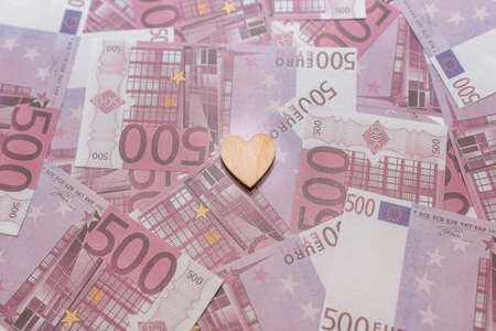 One heart flat lay on the 500 five hundred cash money pile paper background.Selective focus,copy space.の写真素材