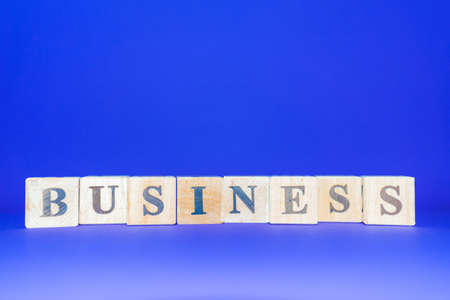 BUSINESS word written on wood blocks number cubes put on blue background.Copy space.の写真素材