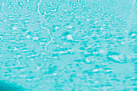 Water drops condensate on white background texture on transparent glass. backdrop glass covered with abstract drops of water.blurred image.の写真素材