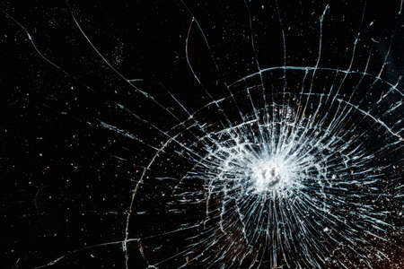 Broken glass texture on black background. Abstract of cracked screen smartphone from shock.の写真素材