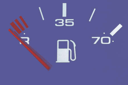 Fuel gauge showing and empty tank.Car Fuel Gauge Showing Empty, close up.Toned.Veri peri purple background color.の写真素材