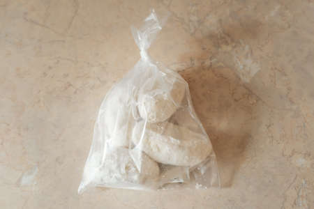 Fast food, unhealthy food.Raw Traditional Lithuanian dish meal cuisine with stuffed meat potato packed in cellophane bag lie on the table.Top view,selective focus.の写真素材