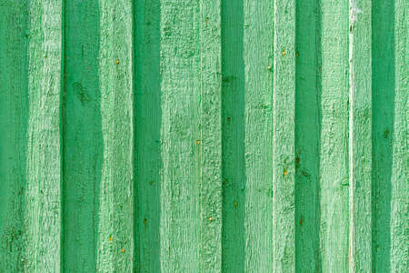 background old green wooden boards close up.Boards are vertical.Outdoors shot.
