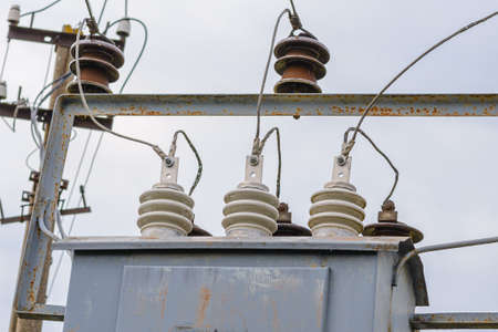 High voltage circuit breaker,insulators and conductors in a power substation.Close up.