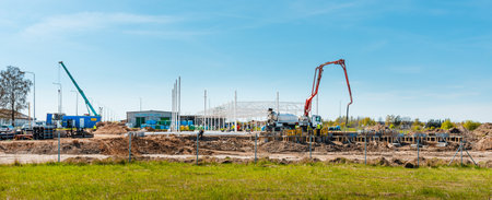 Urban area with machinery, car cement mixer,people are working on construction site. Panoramic view....