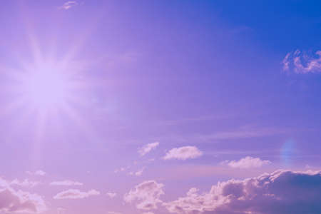 Beautiful pink,purple sunset cloudy sky evening.Landscape,sun sunrays through the white clouds.Toned.の写真素材