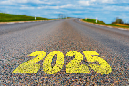 The goal word calendar 2025 written on highway road in the middle of empty asphalt road at golden sunset and beautiful blue sky. Concept for year 2025.の写真素材