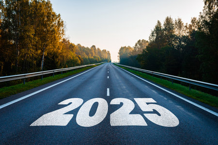 Text 2025 written on the road in the middle of asphalt road with at sunset. New year 2025 or straight forward concept. Concept of planning, goal, challenge, new year resolution.の写真素材