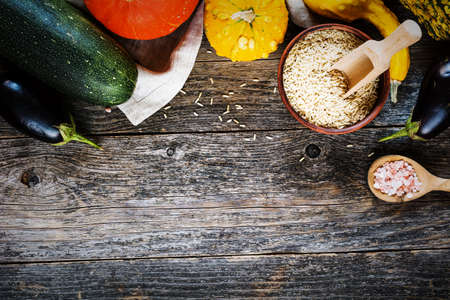 Seasonal vegetables on a wooden background. Cooking ingredients. Border art designの写真素材
