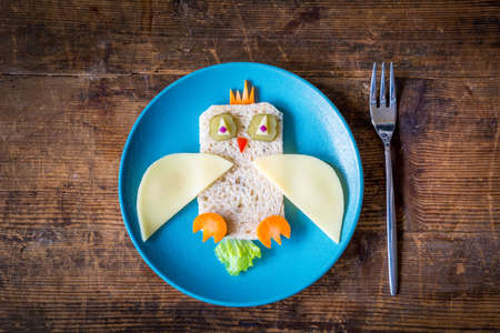 Healthy lunch for kids: funny vegetable sandwich on plateの写真素材