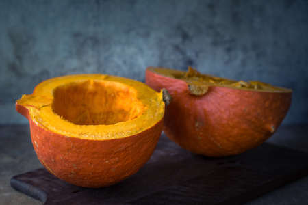 Pumpkin cut on wooden cutting boardの写真素材