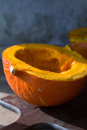 Pumpkin cut on wooden cutting boardの写真素材