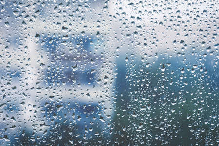 Rainy window, blurry view. Cold tonesの写真素材
