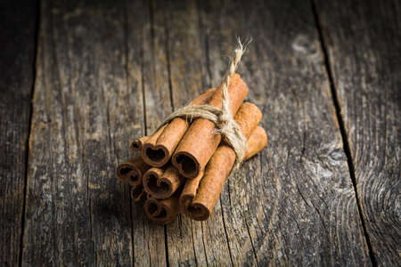 Cinnamon sticks on wooden backgroundの写真素材
