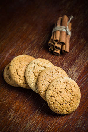 Chocolate chip oatmeal cookies with cinnamon on wooden table, selective focus