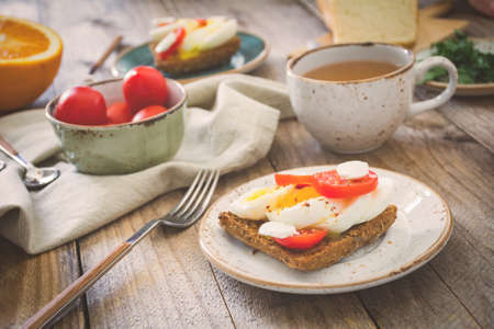 Healthy Breakfast table: toasts, eggs, fruits, vegetables and green teaの写真素材