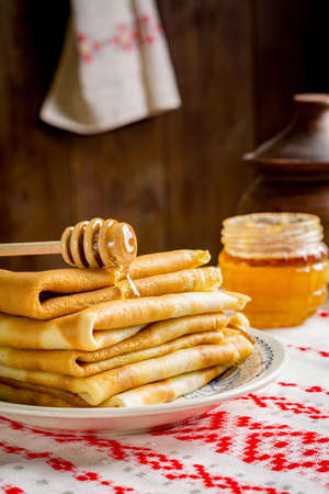 Stack of pancakes with honey. Russian blini for Maslenitsaの写真素材