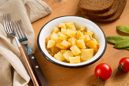 Healthy potato salad in bowl on rustic wooden backgroundの写真素材