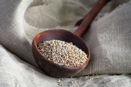 Chia seeds, natural super food in a wooden bowl. Close upの写真素材