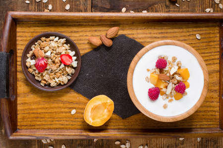 Yogurt with granola and fruits on a tray. Healthy breakfast conceptの写真素材