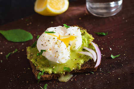 Sandwich with avocado and poached egg, close upの写真素材