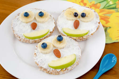Owl cakes for kids breakfast on a plate. Funny creative food for healthy children breakfast.の写真素材