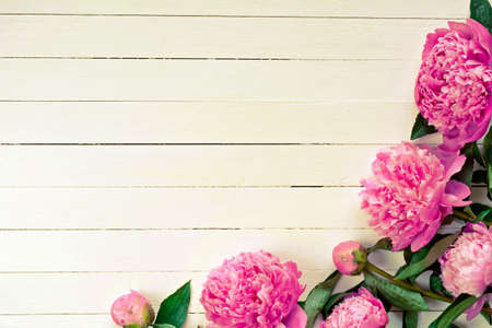 Pink peony flowers on vintage wooden background. Copy space. Wedding, gift card, valentine's day or mothers day background. Retro styleの写真素材
