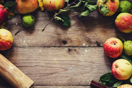 Autumn border from apples, pears and walnuts on old wooden table. Fall, Thanksgiving day and baking...