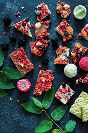 Chocolate barks with dried fruits (strawberries, raspberris, goji berries, blueberries), nuts and...