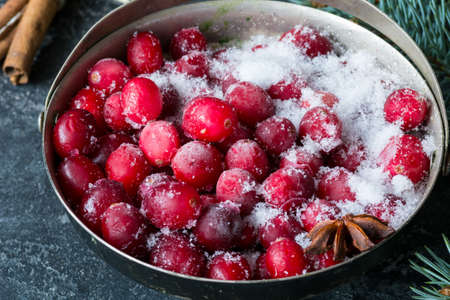 Frozen cranberries in vintage sugar bowl, close up view. Christmas, New Year, winter holidays...