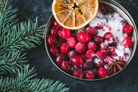 Frozen cranberries in vintage sugar bowl, close up view. Christmas, New Year, winter holidays conceptual still lifeの写真素材