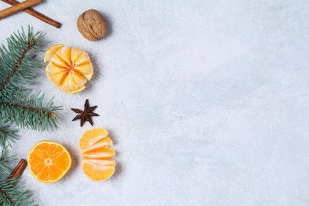 New Year's or Christmas background with mandarin oranges, star anise and fir-tree branch on bright blue background with copy space for text. Great use as wallpaper, design mock up, gretting cardの写真素材