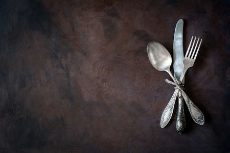 Vintage cutlery / silverware on dark background with copy space for textの写真素材