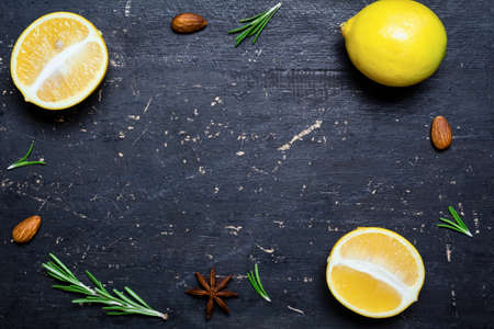 Fresh lemons frame on dark black wooden background. Healthy food cooking background. Copy space for textの写真素材