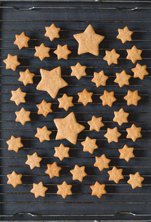 Stars shaped cookies on a cooling rack, top view.の写真素材