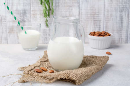 Fresh almond milk in jug on rustic textile. Healthy vegan dairy free milk substitute. Close up viewの写真素材
