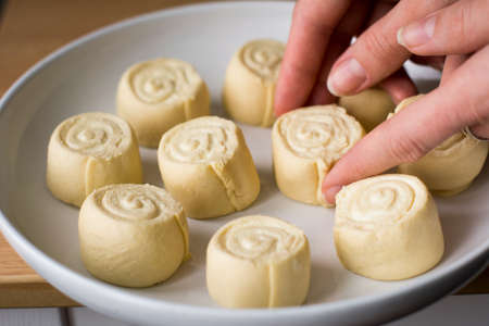 Preparation of cinnamon rolls (pastry, sweet bun).の写真素材