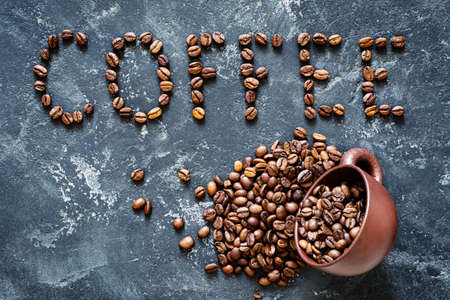 Coffee written with roasted coffee beans. Top view