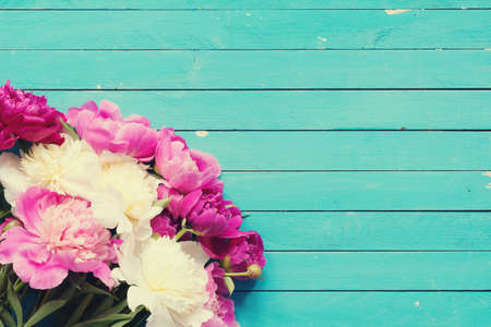 Floral frame / background with beautiful pink, purple and white peonies on old turquoise wooden planks. Shabby chic, vintage flowers for wedding, Happy Mother's Day or Women's dayの写真素材