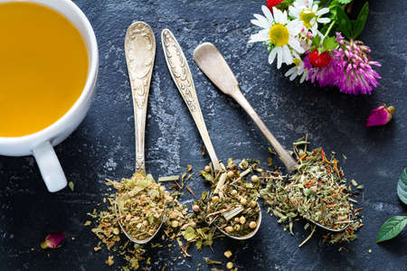Dried herbal tea selection on black concrete bacakground. Health care, healthy lifestyle concept. Closeup viewの写真素材