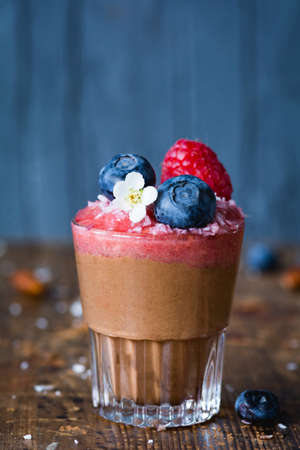 Vegan vegetarian Chocolate Mousse Chocolate Pudding with fresh berry Blueberry and Raspberry in glass. Closeup viewの写真素材