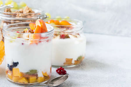 Natural yogurt with fresh fruits, berries and oat granola. Healthy breakfast food, diet fitness...