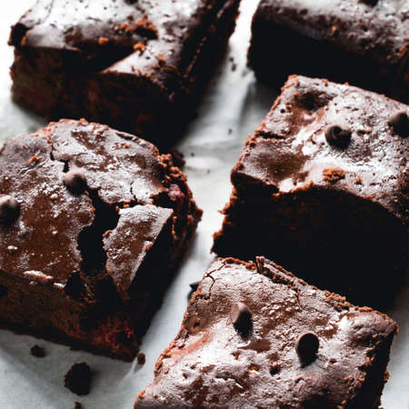 Dark chocolate brownies on baking paper. Closeup view square cropの写真素材
