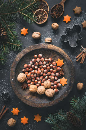 Christmas Winter decorations, walnuts, hazelnuts, Christmas tree branch, spices, cookie cutters and...