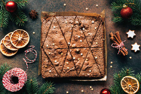 Chocolate brownies and Christmas decorations. Top view. Sweet winter holiday foodの写真素材