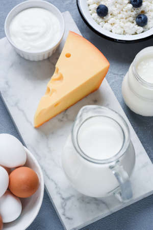 Milk, cheese, sour cream, eggs and yogurt. Dairy products on marble background. Selective focusの写真素材