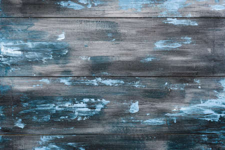 Old painted blue and grey wooden background. Old wooden fence planks. Horizontal view