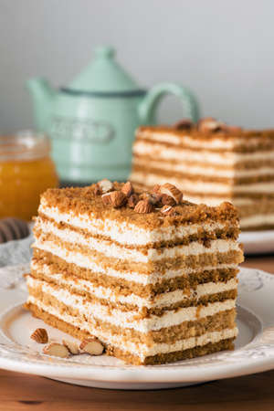 Honey cake Medovik on white plate. Closeup view, toned image