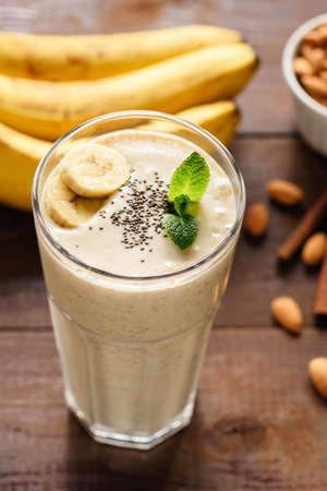 Banana smoothie or milkshake with chia seeds in a glass. Top view, selective focusの写真素材
