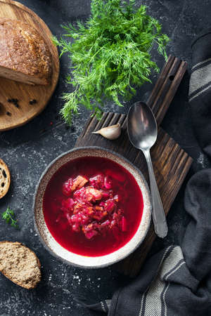 Beet soup Borscht in bowl on stone background. Top view, vertical compositionの写真素材